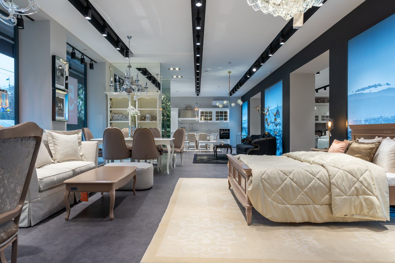 A furnished living room with a sofa and wooden furniture